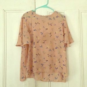 Light salmon colored blouse with floral pattern